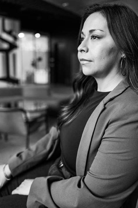 A black-and-white close-up of of Deanna Hernandez, field marketing officer at McDonald’s.
