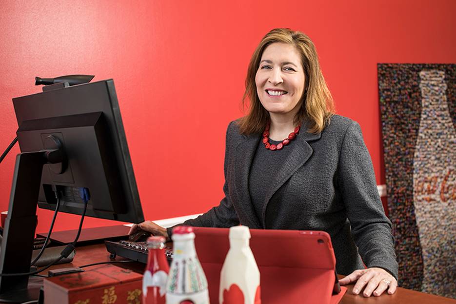 Beatriz Perez, SVP, Coca-Cola, at desk red background